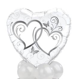 Heart-shaped white balloon with silver heart graphics and white balloons below