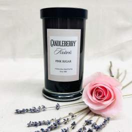 Black candle jar with a pink rose and lavender sprigs