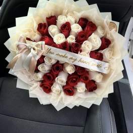 Bouquet of red and white roses with a satin ribbon
