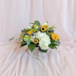Yellow and white floral arrangement in a wooden box