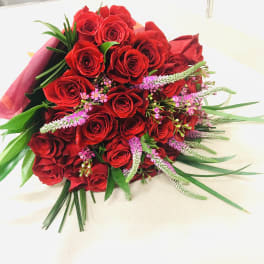 Bouquet of red roses with pink filler flowers and greenery
