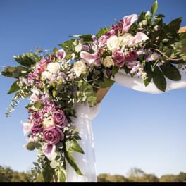 Floral wedding arch with pink and white roses and calla lilies