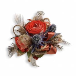 Small boutonniere with red roses, blue thistle, and feathers