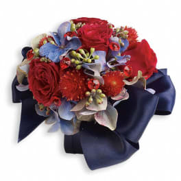 Red roses with blue flowers and a navy ribbon wrap