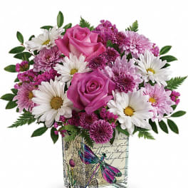 Pink roses and white daisies in a square glass vase with butterfly art