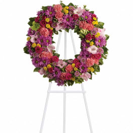 Colorful floral wreath on a white easel stand