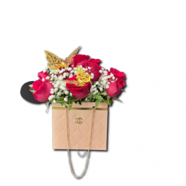 Pink roses with white filler flowers in a blush handbag-style box with gold butterflies.
