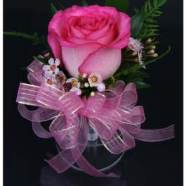 Pink rose in a clear vase with a large pink ribbon bow