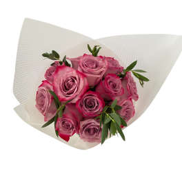 Bouquet of pink roses wrapped in white paper