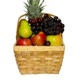 Fruit basket with pineapple, grapes, pears, apples, and mangoes