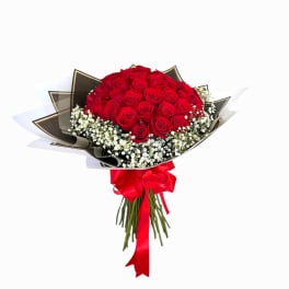 Bouquet of red roses with baby's breath and a red ribbon