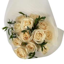 Bouquet of cream roses wrapped in white paper