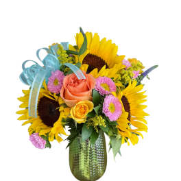 Sunflower and rose bouquet in a green glass vase with blue ribbon