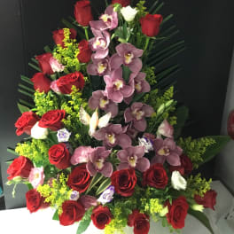 Tall arrangement of red roses and purple orchids