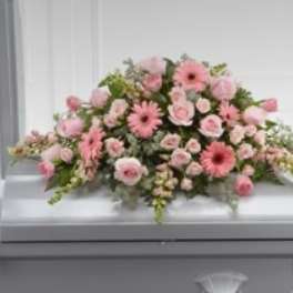Pink floral casket spray with gerbera daisies and roses