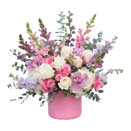 Pink and white mixed flower arrangement in a pink vase