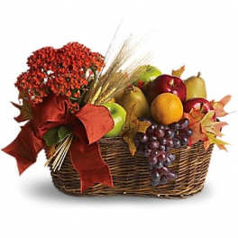 Autumn gift basket with fruit, red flowers, and a large ribbon