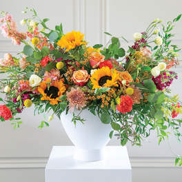 Colorful mixed flower arrangement in a white vase