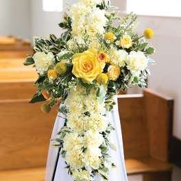 Yellow and white floral spray on a stand