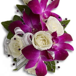 White roses and purple orchids arranged with ribbon accents