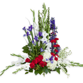 Tall floral arrangement with white, purple, and red flowers