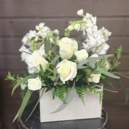 White roses and white blossoms in a rectangular box arrangement