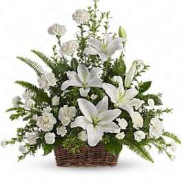 White lilies and carnations in a wicker basket