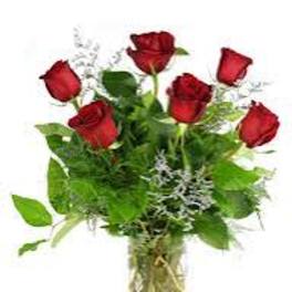 Bouquet of red roses with greenery in a clear vase