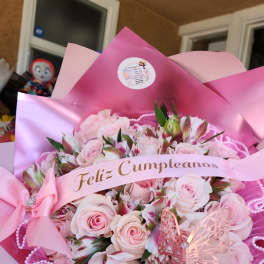 Pink rose bouquet with a birthday ribbon and butterfly decoration