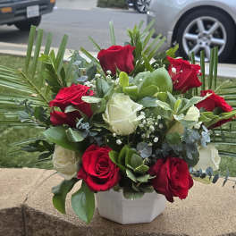 Bouquet of red and white roses in a white vase