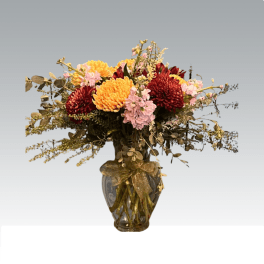 Bouquet of red, yellow, and pink flowers in a glass vase