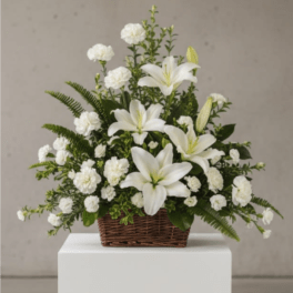 White lilies and carnations in a wicker basket