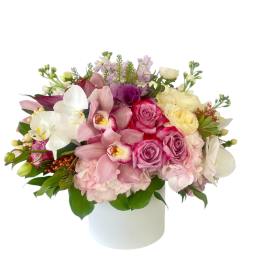 Pink and white mixed flower arrangement in a white vase