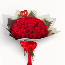 Bouquet of red roses with a heart topper and red ribbon
