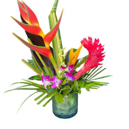 Tropical flower arrangement in a blue glass vase with red heliconia and purple orchids