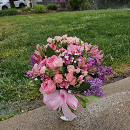 Pink and purple mixed bouquet with a pink ribbon bow