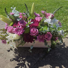 Pink and white floral arrangement in a rectangular wooden box