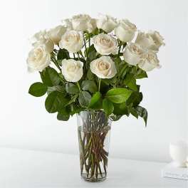 White roses arranged in a clear glass vase
