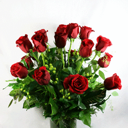 Red roses arranged in a clear glass vase