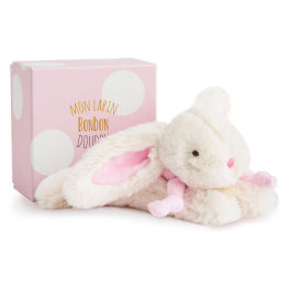 Plush white bunny with pink ears beside a pink gift box