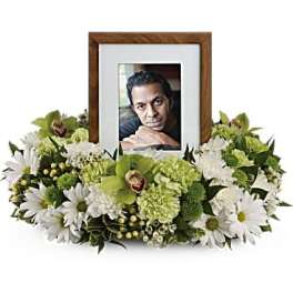 Framed photo surrounded by white and green flowers