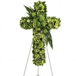 Green floral cross arrangement on a metal easel
