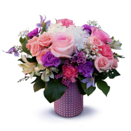 Pink and purple mixed bouquet in a textured lavender vase