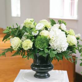 White floral arrangement in a dark vase