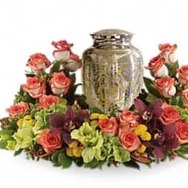 Pink roses arranged around a decorative urn centerpiece