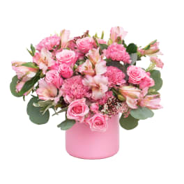 Pink roses and alstroemeria arranged in a pink vase