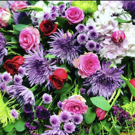 Mixed bouquet of pink, red, and purple flowers