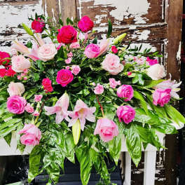 Pink roses and lilies arranged in a large floral display