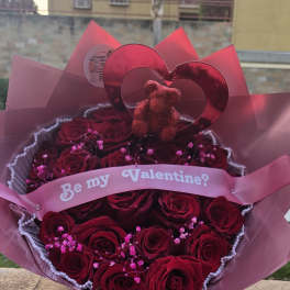 Bouquet of red roses with a pink "Be my Valentine?" ribbon and heart topper