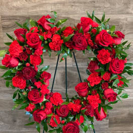 Red rose and carnation wreath on a stand